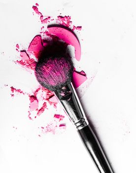 Beauty texture, cosmetic product and art of make-up concept - Brush with crushed eyeshadow and powder close-up isolated on white background