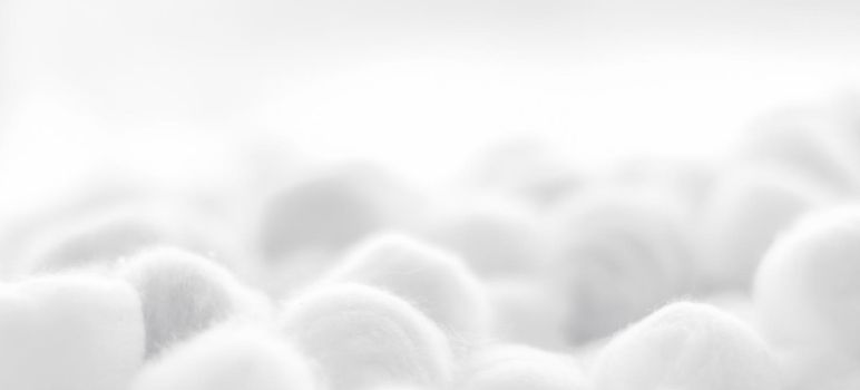 Cosmetology, branding and cleanliness concept - Organic cotton balls background for morning routine, spa cosmetics, hygiene and natural skincare beauty brand product as healthcare and medical design