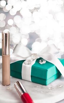 Cosmetic branding, Christmas glitter and girly blog concept - Holiday make-up foundation base, concealer and green gift box, luxury cosmetics present and blank label products for beauty brand design