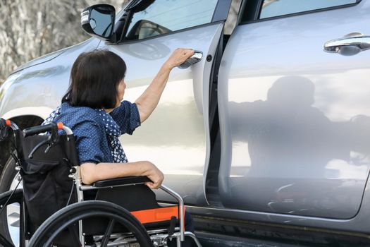 Elderly woman open door car