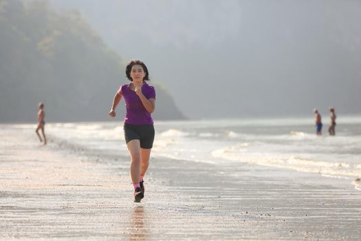 Fitness runner woman on ao nang beach , Krabi , Thailand