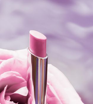 Cosmetic branding, luxe and fashion concept - Pink lipstick and rose flower on liquid background, waterproof glamour make-up and lip gloss cosmetics product for luxury beauty brand holiday design