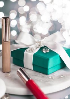 Cosmetic branding, Christmas glitter and girly blog concept - Holiday make-up foundation base, concealer and green gift box, luxury cosmetics present and blank label products for beauty brand design