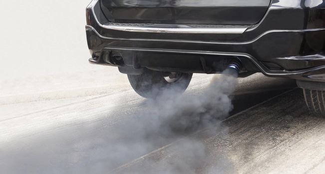 air pollution crisis in city from diesel vehicle exhaust pipe on road