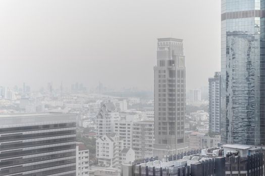 Downtown skyscrapers of the city of Bankok. Poor visibility, smog, caused by dust and smoke high level PM2.5  air pollution.