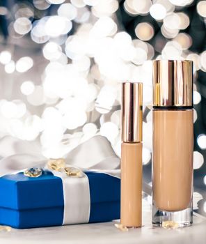 Cosmetic branding, Christmas glitter and girly blog concept - Holiday make-up foundation base, concealer and blue gift box, luxury cosmetics present and blank label products for beauty brand design