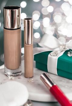 Cosmetic branding, Christmas glitter and girly blog concept - Holiday make-up foundation base, concealer and green gift box, luxury cosmetics present and blank label products for beauty brand design