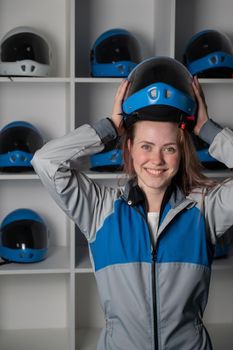 Caucasian woman puts on a helmet before flying in a wind tunnel. Free fall simulator