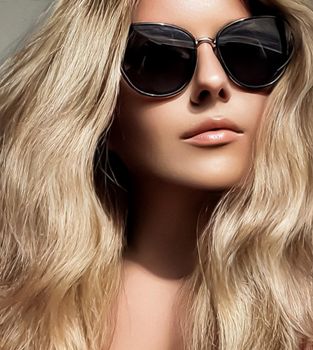 Luxury fashion, blonde hairstyle and accessories, beauty face portrait of a woman with long blond hair, wearing chic sunglasses, glamour style close-up
