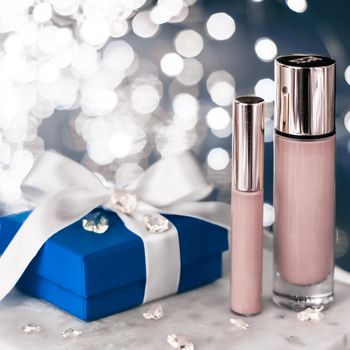 Cosmetic branding, Christmas glitter and girly blog concept - Holiday make-up foundation base, concealer and blue gift box, luxury cosmetics present and blank label products for beauty brand design