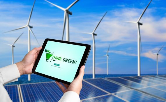 Green business transformation for environment saving and ESG business concept. Businessman using tablet to set corporate goal toward environmental friendly management and alternative clean energy use.