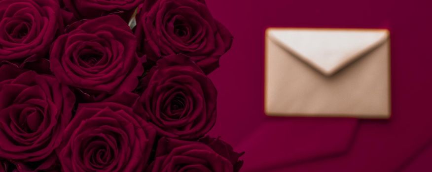 Holidays gift, floral present and happy relationship concept - Love letter and flowers delivery on Valentines Day, luxury bouquet of roses and card on maroon background for romantic holiday design