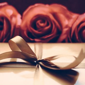 Vintage design, shop sale promotion and happy surprise concept - Luxury holiday golden gift box and bouquet of roses as Christmas, Valentines Day or birthday present