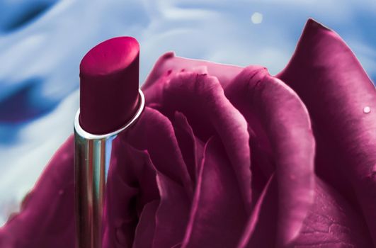 Cosmetic branding, luxe and fashion concept - Purple lipstick and rose flower on liquid background, waterproof glamour make-up and lip gloss cosmetics product for luxury beauty brand holiday design