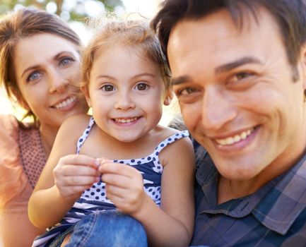 What a happy family. Portrait of a young family enjoying the outdoors