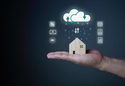 Human hand holding home model and cloud icon. cloud computing concept . Connect communication equipment  information and technology in home.