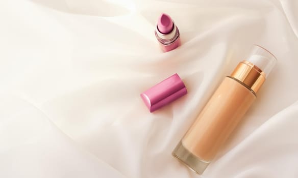 Cosmetic branding, glamour and skincare concept - Beige tonal cream bottle make-up fluid foundation base and pink lipstick on silk background, cosmetics products as luxury beauty brand holiday design