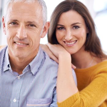 Happy at home together. a young woman being affectionate towards her older husband