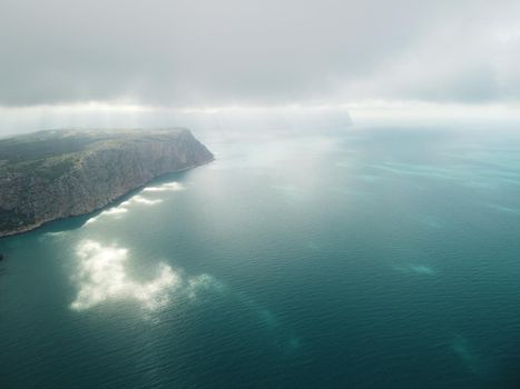 Aerial panoramic view of beautiful sunset above sea. Beautiful seascape. Sun glare, small waves on the water surface. Evening. Horizon. Nobody. No people. Copy space. Never-ending beauty of nature