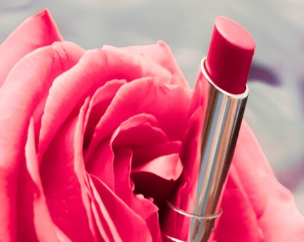 Cosmetic branding, luxe and fashion concept - Pink lipstick and rose flower on liquid background, waterproof glamour make-up and lip gloss cosmetics product for luxury beauty brand holiday design