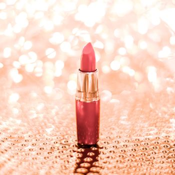 Cosmetic branding, sale and glamour concept - Coral lipstick on rose gold Christmas, New Years and Valentines Day holiday glitter background, make-up and cosmetics product for luxury beauty brand