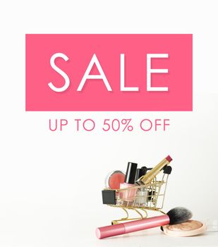 Sale banner. Shopping trolley full of make up and cosmetic goods on white background. Black friday concept. Sale and discount concept. Goods for women. Closeup of a basket with products for make-up.