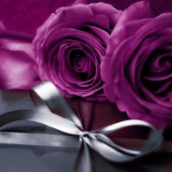 Luxurious design, shop sale promotion and happy surprise concept - Luxury holiday silver gift box and purple roses as Christmas, Valentines Day or birthday present