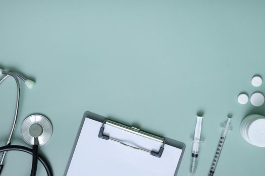 Pills, stethoscope with laptop and tablet at doctor's workplace. Medical flat lat with copy space.