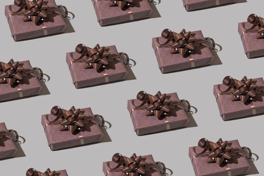 Brown gift box pattern with bow on gray background. Christmas minimalist concept photo. High quality photo