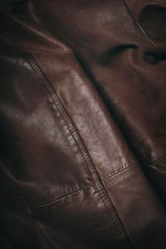 Brown leather material. Highly detailed closeup of leather texture. Cool background.