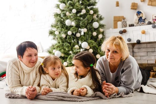 happy young family holding christmas gift and smiling.