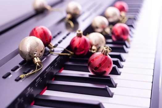 Piano keyboard with Christmas garland close up.
