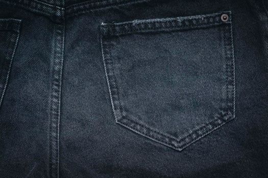 Jeans texture with pocket. Highly detailed closeup of black jeans. Cool background.