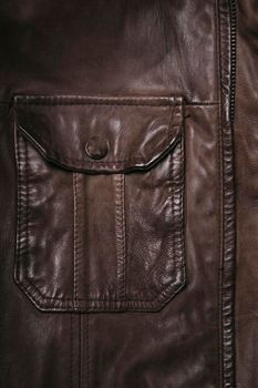 Brown leather material. Highly detailed closeup of leather texture. Cool background.