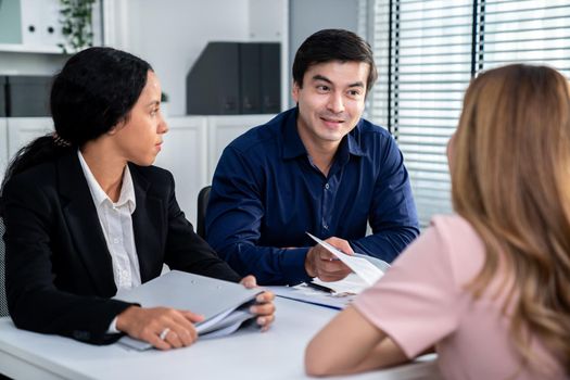 A young female asian candidate tries to impress her interviewer by being competent. International company, multicultural environment in workplace.