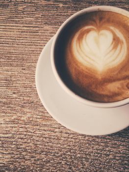 Morning drink, breakfast and rustic style concept - Cup of hot cappuccino in a cafeteria, coffee on a wooden table in cafe