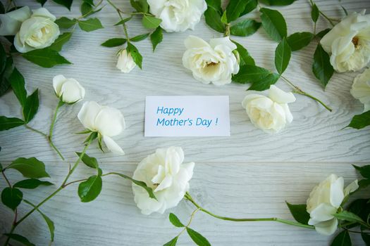 beautiful background of many white roses on a light wooden