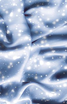 Winter fashion, shiny fabric and glamour style concept - Magic holiday blue soft silk flatlay background texture with glowing snow, luxury beauty abstract backdrop