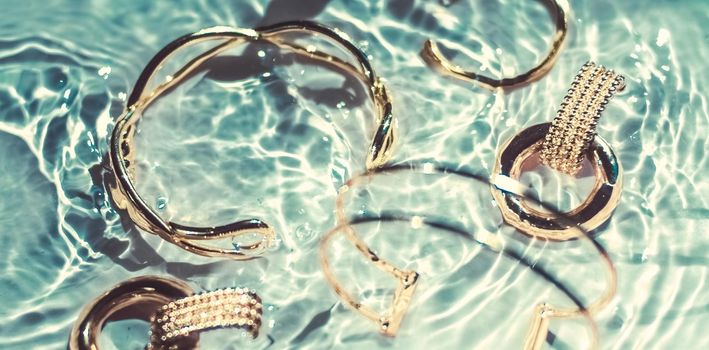 Jewellery branding, fashion gift and luxe shopping concept - Golden bracelets, earrings, rings, jewelery on emerald water background, luxury glamour and holiday beauty design for jewelry brand ads
