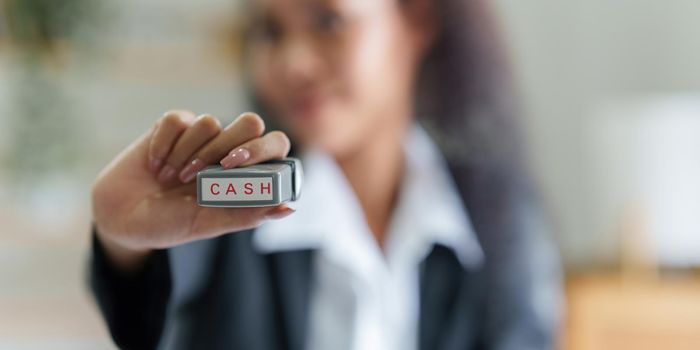 Business Accountant woman Hand Stamping On Cash on bill. finance concept.