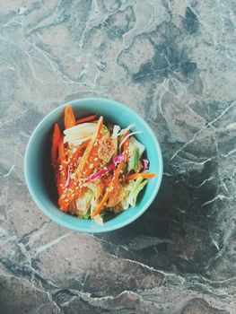 Vegan dieting, eating out and oriental cuisine concept - Vegetarian asian vegetable salad served in a bowl in japanese restaurant, healthy diet food