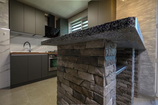 kitchen counter closeup at cozy modern trendy gray kitchen