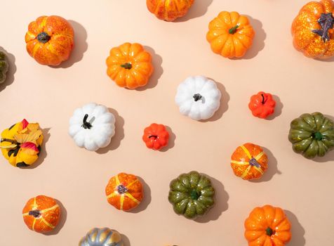 Pumpkin pattern, decorative pumpkins on orange background top view. Autumn, fall, halloween concept. Trend shadow.