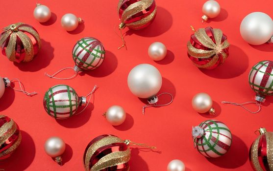 red and white shiny christmas balls on red backgroud, pattern. Winter, Cristmas and New year concept. Top view, flat lay