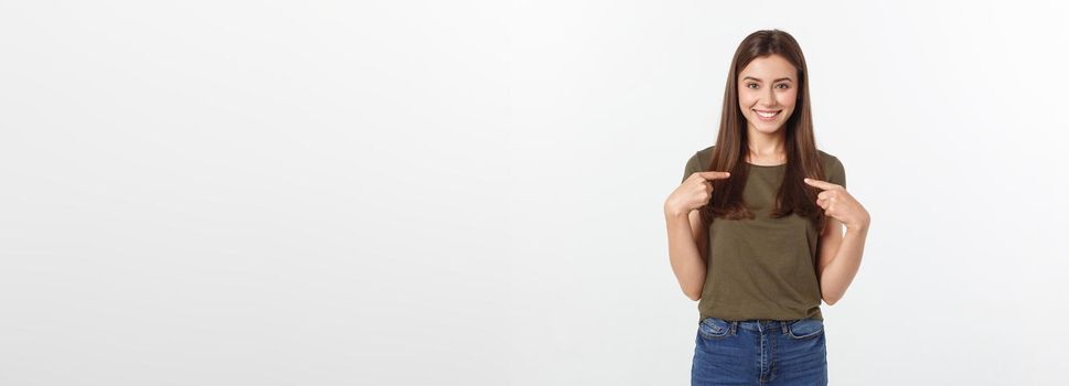 Portrait happy and surprised young lady standing isolated over grey background. Looking camera pointing