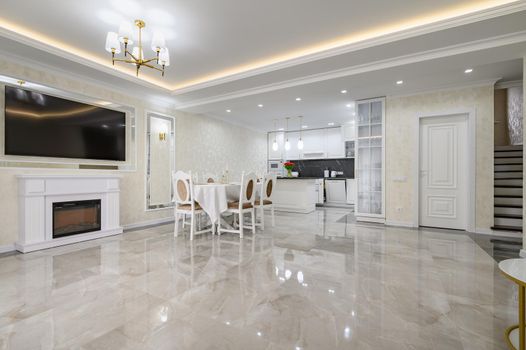 Luxurious white large home kitchen with dining table and marble floor, lots of copyspace