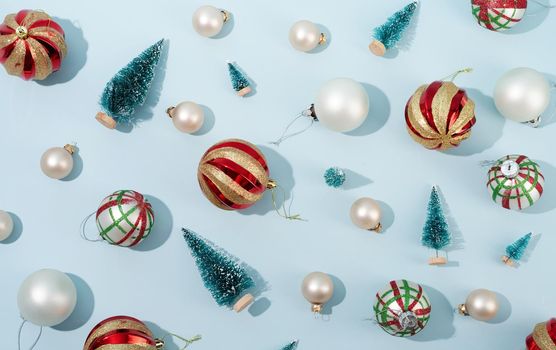 red and white shiny christmas balls on blue pastel backgroud, pattern, Winter, Cristmas and New year concept. Top view, flat lay