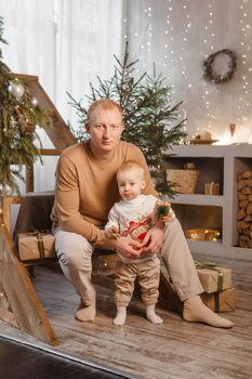 Dad and his little son in a magical Christmas atmosphere. The concept of family relations and New Year celebrations