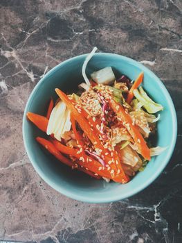 Vegan dieting, eating out and oriental cuisine concept - Vegetarian asian vegetable salad served in a bowl in japanese restaurant, healthy diet food