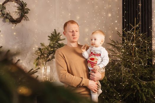 Dad and his little son in a magical Christmas atmosphere. The concept of family relations and New Year celebrations